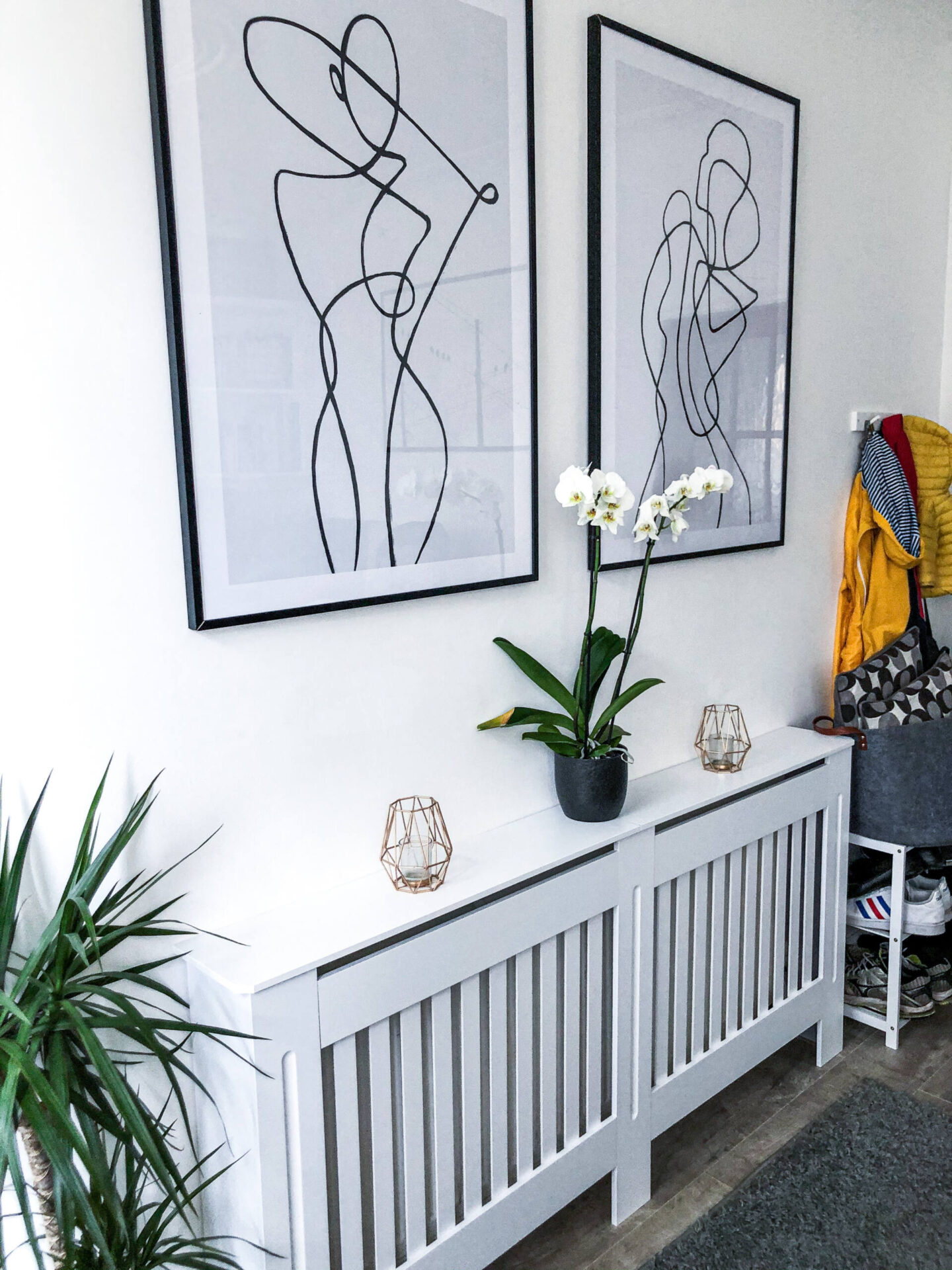 Desenio line art posters above a radiator cover