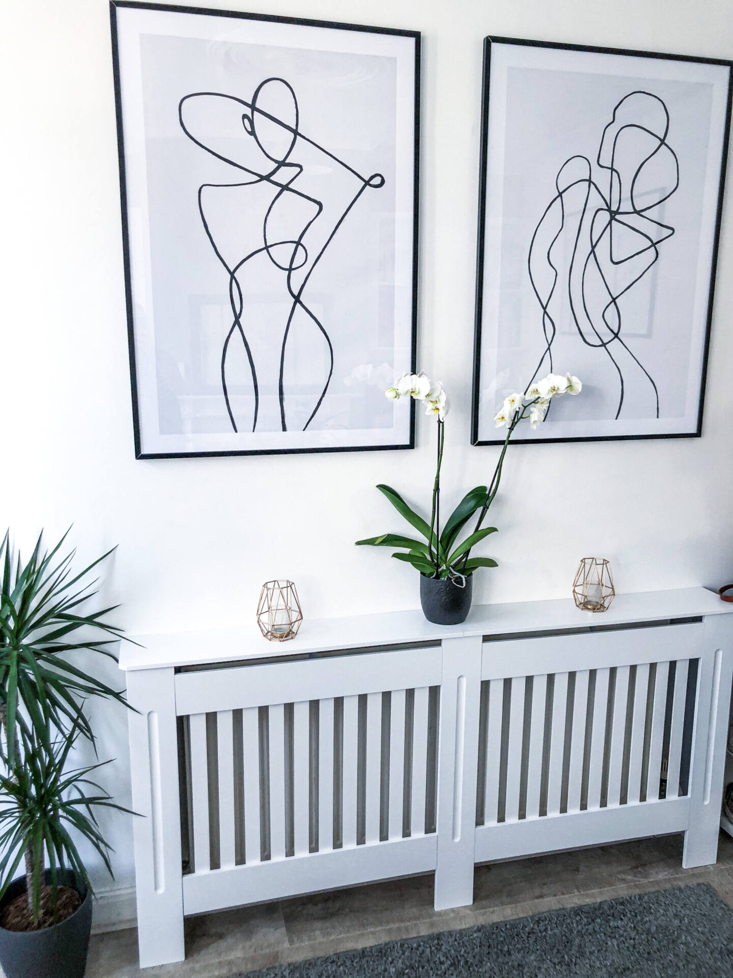 Desenio line art posters above a radiator cover